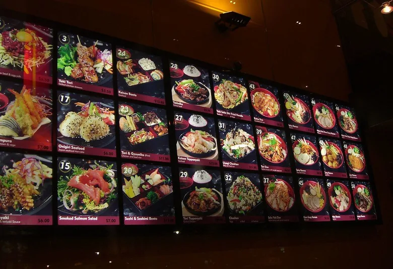 Casual Asian restaurant menu board with many dish photos