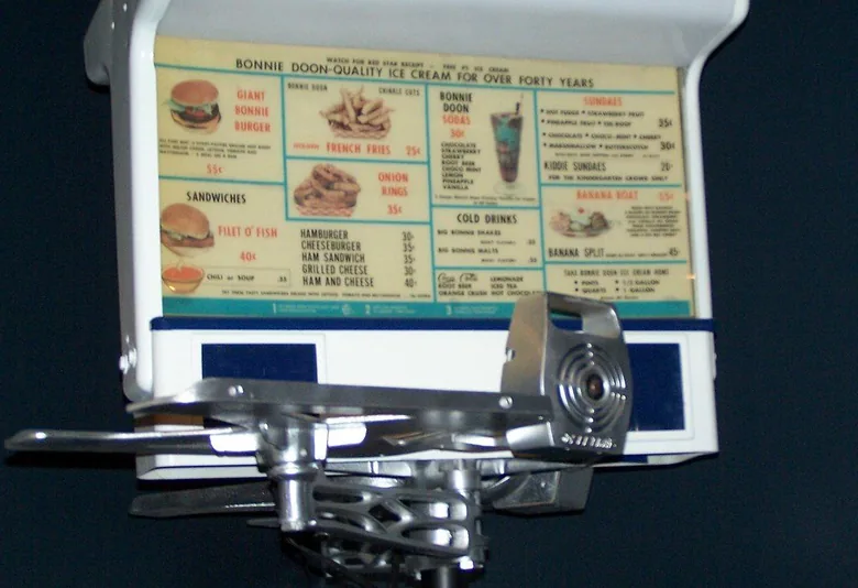 Retro drive-in printed menu board above a service counter